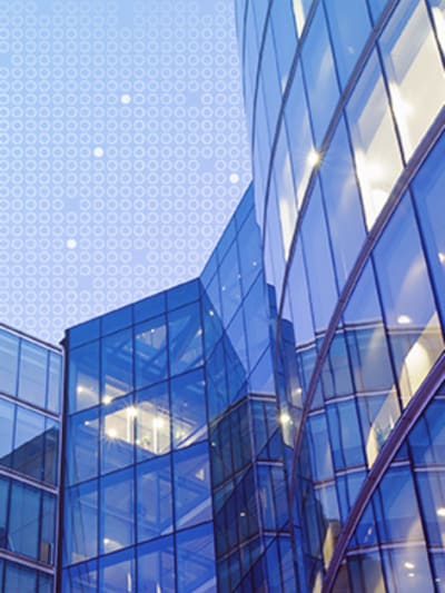 Multistory glass and steel building against a blue sky.